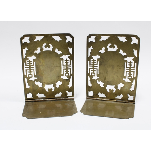 403 - A pair of Chinese brass bookends, pierced design with engraved bat pattern and with oval cloisonné p... 