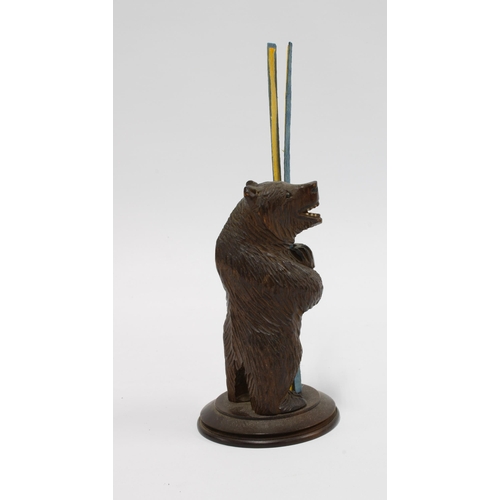 414 - Black Forest carved wood bear taper stick holder, modelled standing on a circular base, 12cm