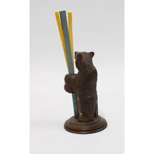 414 - Black Forest carved wood bear taper stick holder, modelled standing on a circular base, 12cm