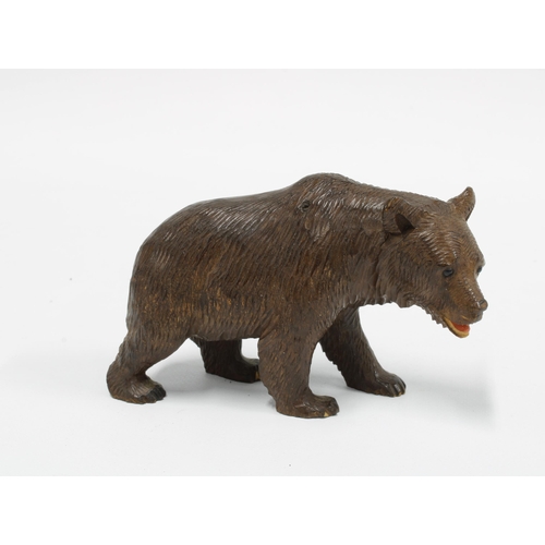 415 - Black Forest carved wood bear, modelled standing on a all fours,  10cm long