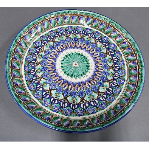 428 - Large pottery charger with Middle Eastern pattern. 37cm.