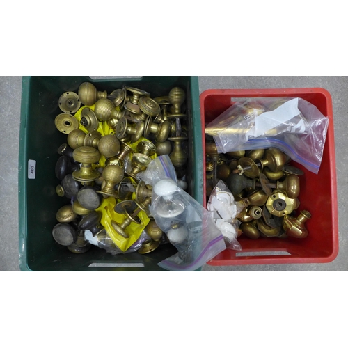 462 - architectural salvage - two boxes of doorknobs and, mainly brass, brass and wood escutcheons, etc  (... 