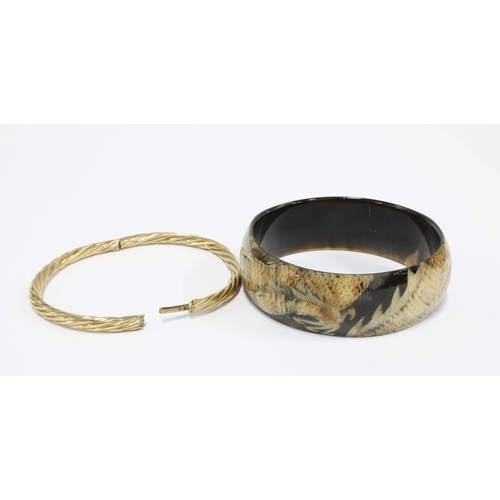 56 - 9ct gold stiff hinged bangle and a modern bangle with dragon pattern (2)