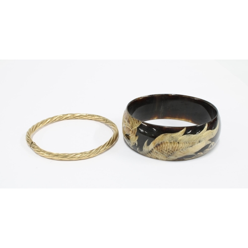 56 - 9ct gold stiff hinged bangle and a modern bangle with dragon pattern (2)