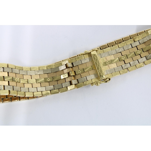 77 - Vintage 18ct gold bracelet with seven rows of textured flat links, stamped 750