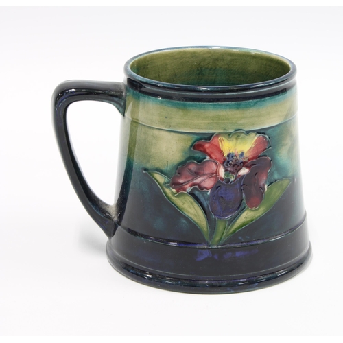 84 - Moorcroft Orchids pattern tankard with a blue and green ground, impressed facsimile signature, 10cm