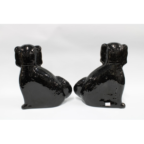 145 - Pair of black glazed chimney spaniels, 31cm (2)