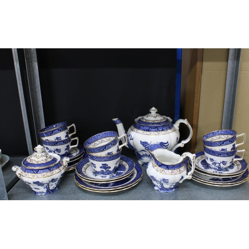 150 - Willow pattern blue and white dinner service and teaset together with a vase, candlesticks, etc tall... 