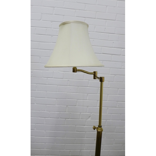 204 - Adjustable brass standard lamp with rise and fall action, complete with shade. 160cm high.