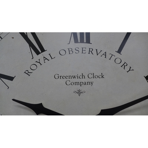 208 - Greenwich Clock Company, large circular wall clock with Roman numerals,  70 cm.