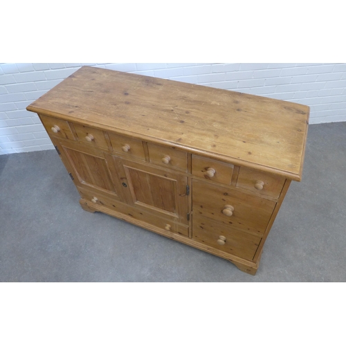 211 - Pine dresser, the rectangular top over an arrangement of drawers and two cupboard doors. 91 x 129 x ... 