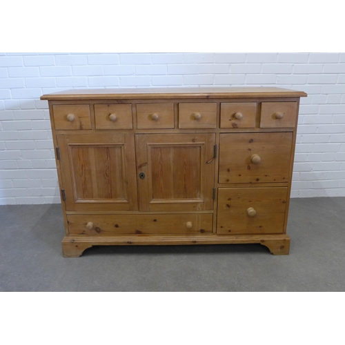 211 - Pine dresser, the rectangular top over an arrangement of drawers and two cupboard doors. 91 x 129 x ... 