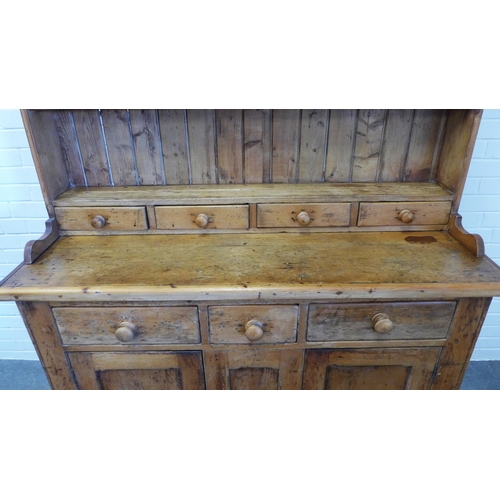 216 - Large pine kitchen dresser, with stepped cornice over shelved plate back with four short spice drawe... 