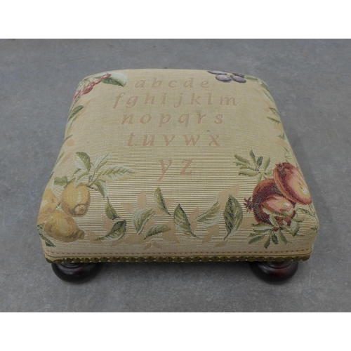 221 - Small tapestry footstool on bun feet. 17 x 34 x 34cm.