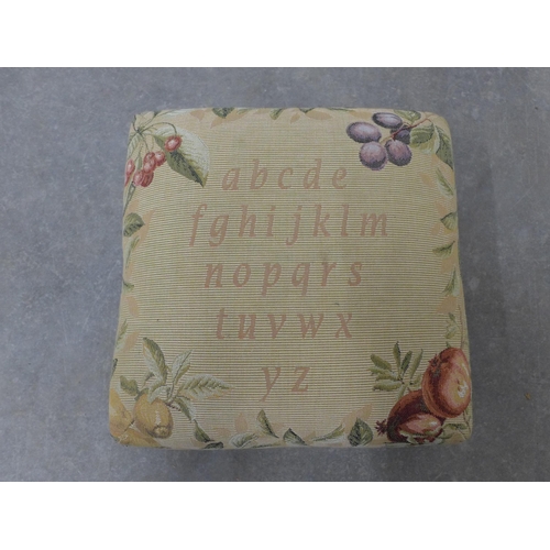 221 - Small tapestry footstool on bun feet. 17 x 34 x 34cm.