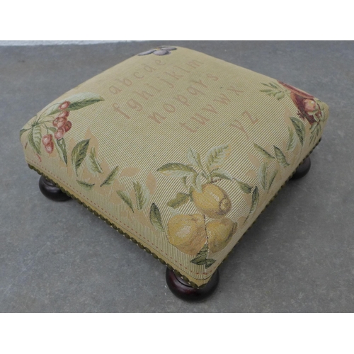 221 - Small tapestry footstool on bun feet. 17 x 34 x 34cm.