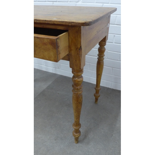 223 - Pine desk with rounded rectangular top above a frieze drawer, on ring turned legs, 76 x 93 x 52cm.