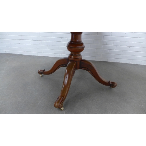 226 - Mahogany pedestal tilt top table, on a baluster turned column with ceramic castors,  75 x 137 x 103c... 