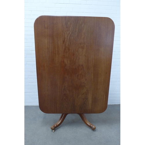 226 - Mahogany pedestal tilt top table, on a baluster turned column with ceramic castors,  75 x 137 x 103c... 