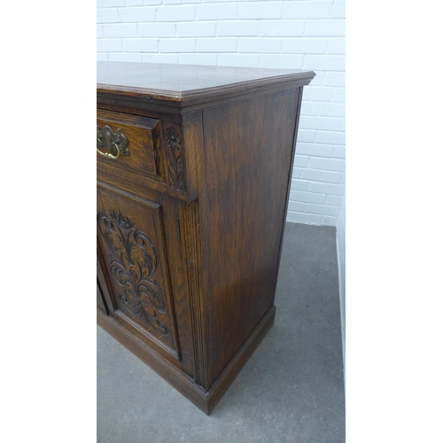 230 - An oak sideboard, moulded rectangular top above two short frieze drawers and two cupboard doors rais... 