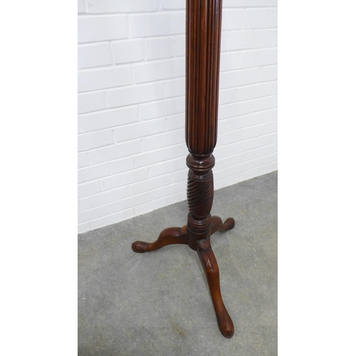 239 - Mahogany torchere stand, the circular dished top on a reeded column and tripod base. 138 x 57cm.