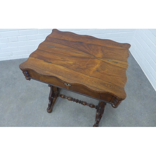 246 - 19th century rosewood sewing table, the serpentine top with a lift up section, opening to reveal a f... 