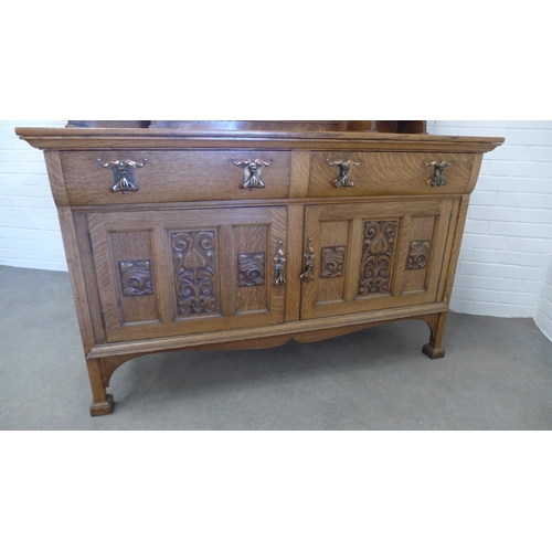 258 - Art Nouveau oak sideboard, with a ledgeback top above a dentil cornice with carved frieze and triple... 