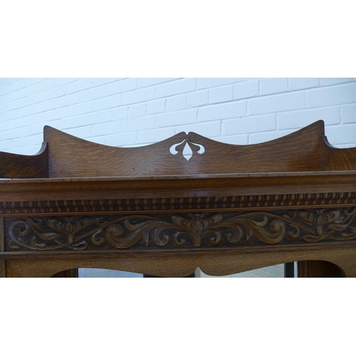 258 - Art Nouveau oak sideboard, with a ledgeback top above a dentil cornice with carved frieze and triple... 