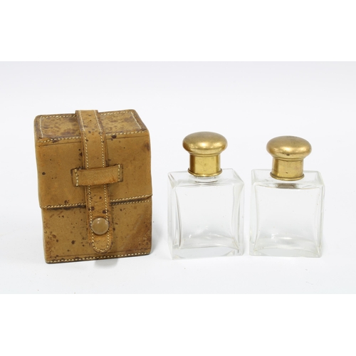 26 - A pair of early 20th century glass scent bottles with gilt metal lids and internal glass stoppers wi... 