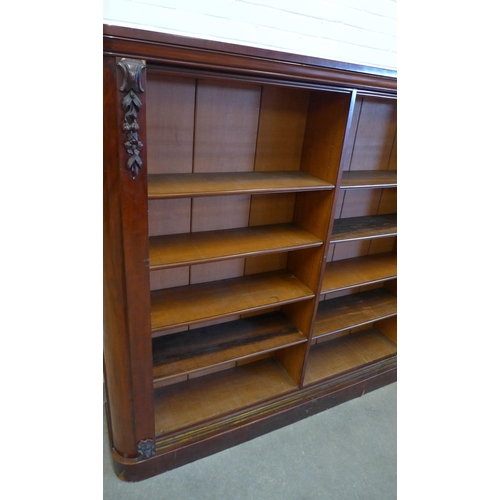 271 - Two mahogany open bookcases, each far end with moulded flowereheads, designed to sit beside each oth... 