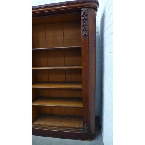 271 - Two mahogany open bookcases, each far end with moulded flowereheads, designed to sit beside each oth... 