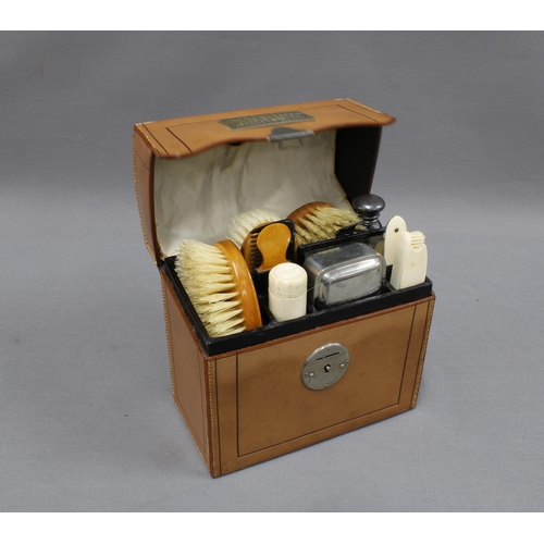 318 - Victorian Gents leather cased grooming set with fruitwood backed brushes and bone handled accessorie... 