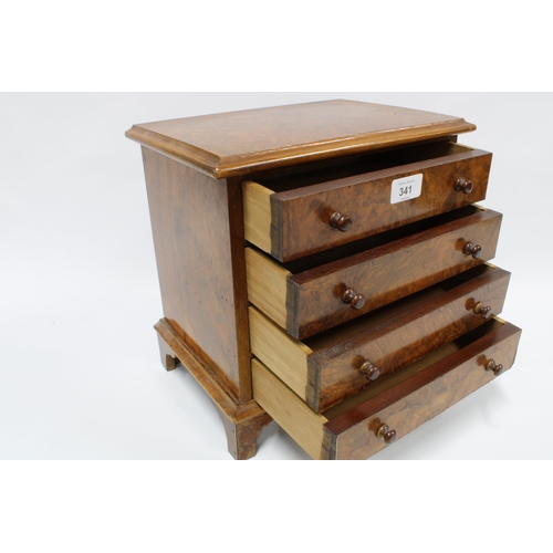 341 - Miniature walnut chest of drawers with rectangular top and four long drawers with bun handles,  on b... 