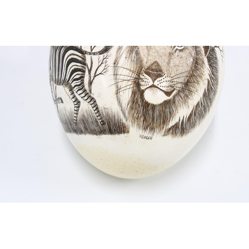 397 - Ostrich egg painted with a lion and a zebra, signed Roger, approx. 18cm high