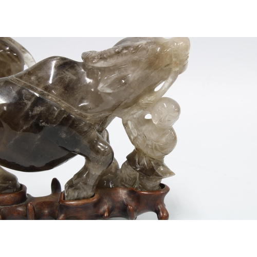 399 - A pair of rock crystal carved water buffalo, modelled standing on associated hardwood bases 20cm lon... 