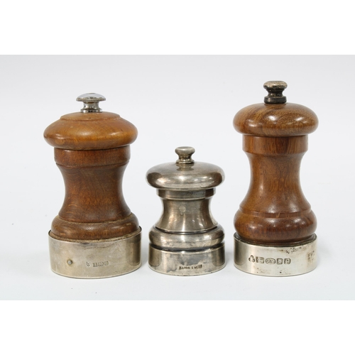 83 - Two silver mounted pepper grinders, one with London 2004 hallmarks and the other Birmingham 1979, to... 