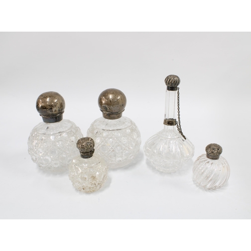 91 - A collection of late 19th and early 20th century silver mounted glass scent bottles, tallest 16cm  (... 