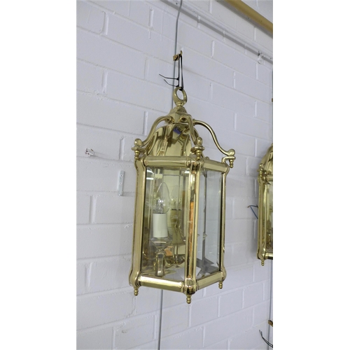 412 - Pair of heavy brass lantern style wall lights with glazed panels, three internal candle style lights... 