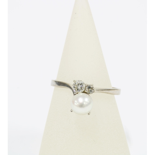 1 - Pearl and diamond ring, the large cultured pearl offset by two brilliant cut diamonds, on a plain wh... 
