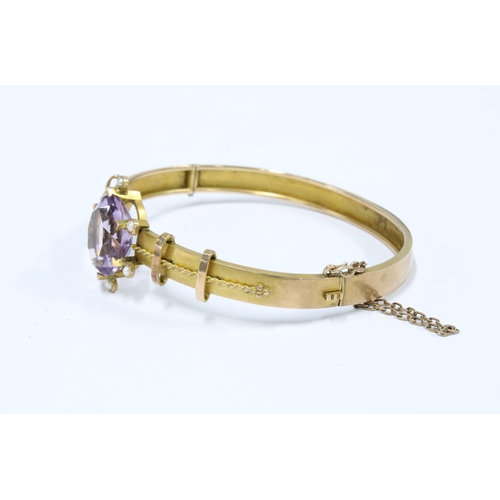 23 - Victorian 9ct gold amethyst and seed pearl bangle, Birmingham 1893