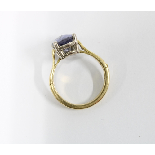 42 - 18ct gold Iolite dress ring, claw set with a single stone with facet cuts,  hinged band stamped 18k,... 