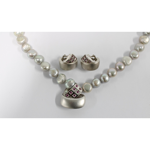45 - 18ct white gold and ruby set pendant, suspended on a strand on grey cultured pearls together with a ... 