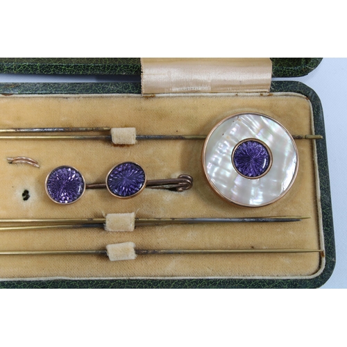 53 - Edwardian gilt metal and purple enamel dress set comprising two mother of pearl hatpins, a buckle, t... 
