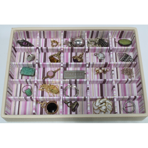 61 - A 'Stackers' cream leather jewellery box, four trays containing a collection of costume jewellery to... 