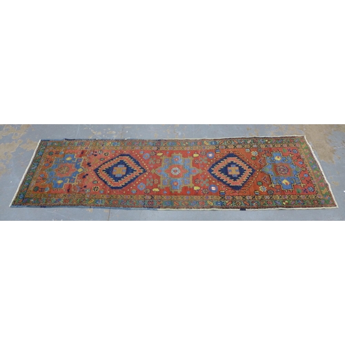 201 - Late 19th / early 20th century Persian runner, red field with five medallions within flowerhead bord... 