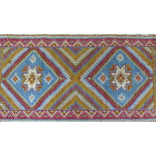 202 - 20th century  Moroccan rug, orange field with two  medallions within multiple flowerhead borders, wi... 