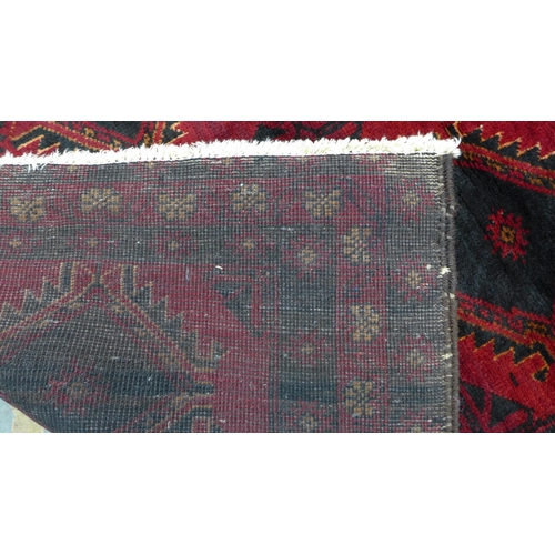 217 - Afghan rug, red field with two rows of six guls,  165 x 100