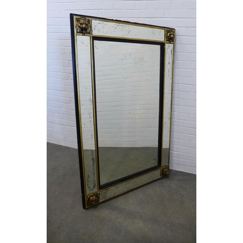 234 - Large wall mirror, the rectangular plate within an ebonised and parcel gilt frame with lion mask cor... 