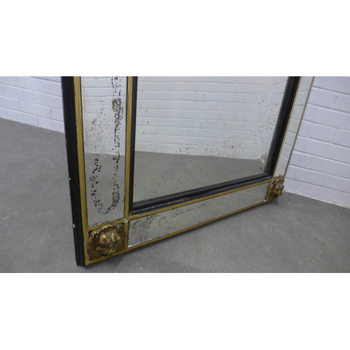 234 - Large wall mirror, the rectangular plate within an ebonised and parcel gilt frame with lion mask cor... 