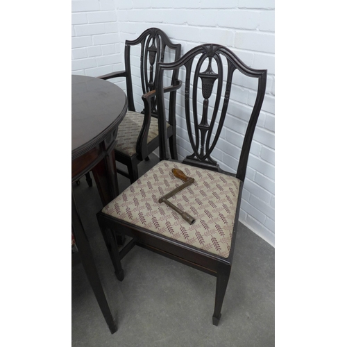 239 - Mahogany extending dining table with a set of 10 chairs including two carver chairs. 75 x 241 x 122c... 